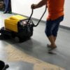 Ảnh cận cảnh bàn chải xoay và thùng chứa của máy quét rác AS-690.
